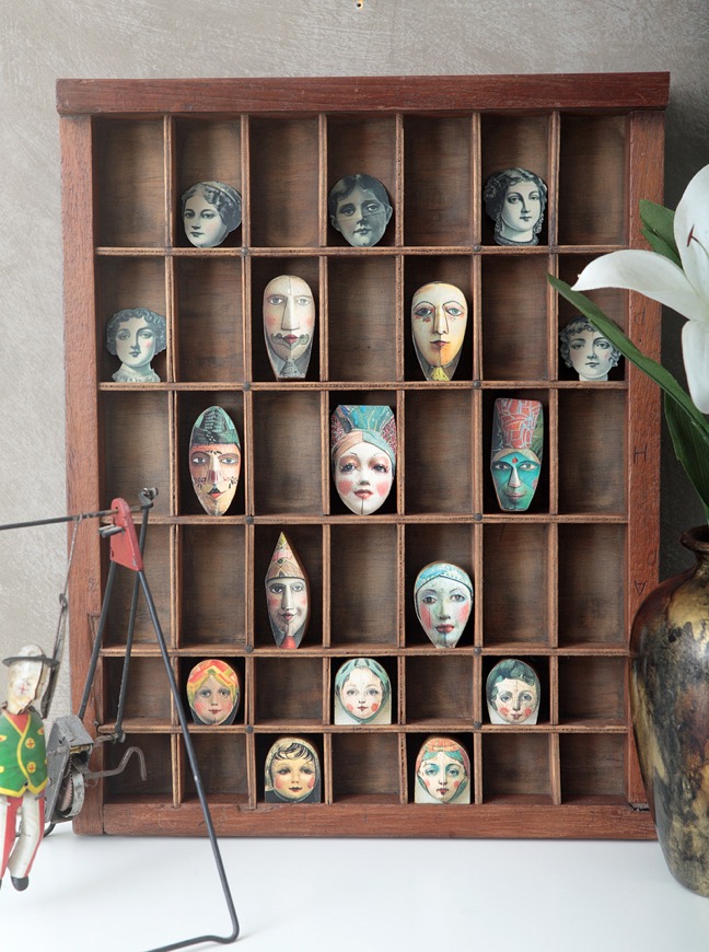 Antique printers type case re purposed and up cycled as a display of quirky wooden face figures