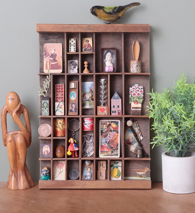 Quirky display of little vintage items in an old printers tray type case drawer