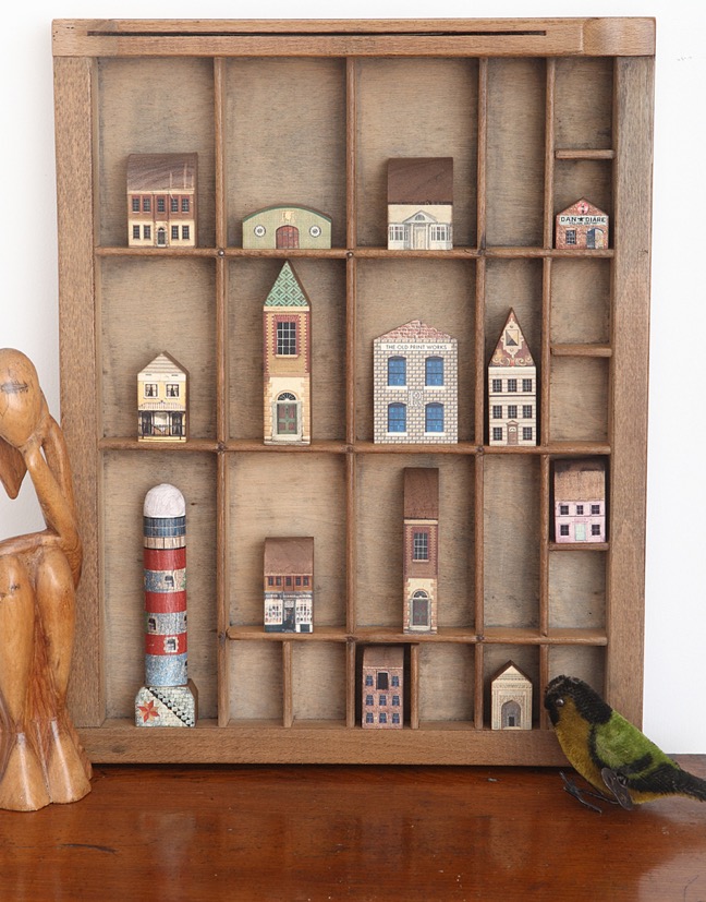 Up cycled printers tray type case drawer with a display of quirky little wooden houses 