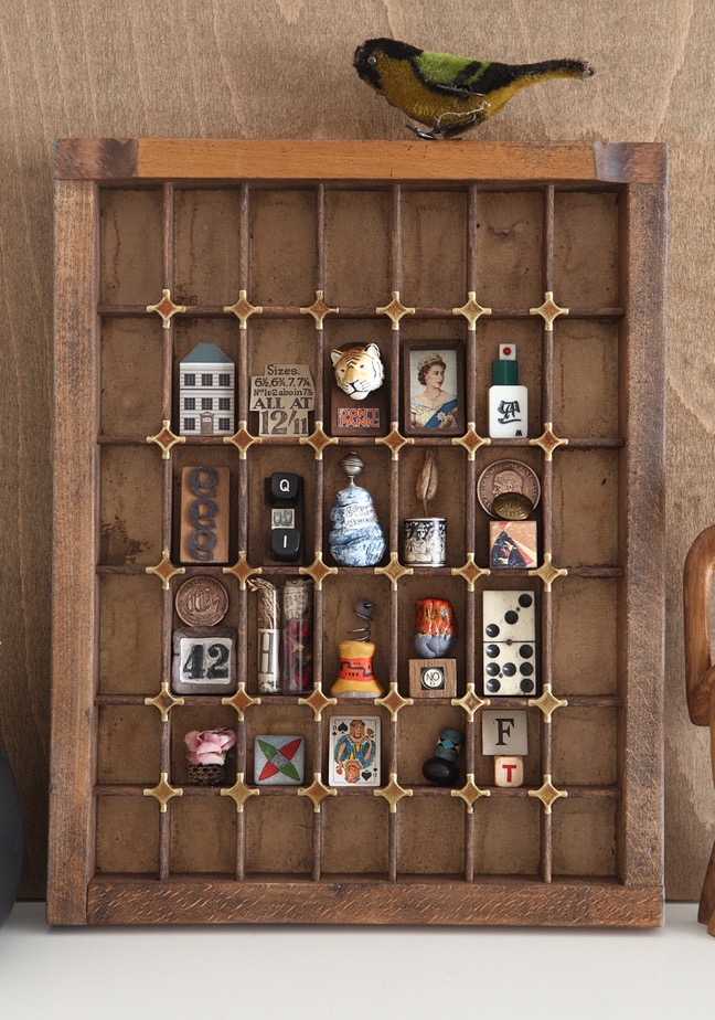 Display of quirky little curios and collectables in old letterpress type case