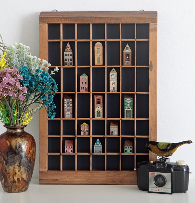 Vintage letterpress printers type case used as a display case for vintage syle wooden houses & buildings 