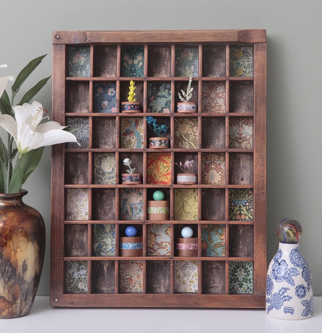 Decorative display of William Morris prints and wooden vases in re purposed letterpress printers tray drawer type case