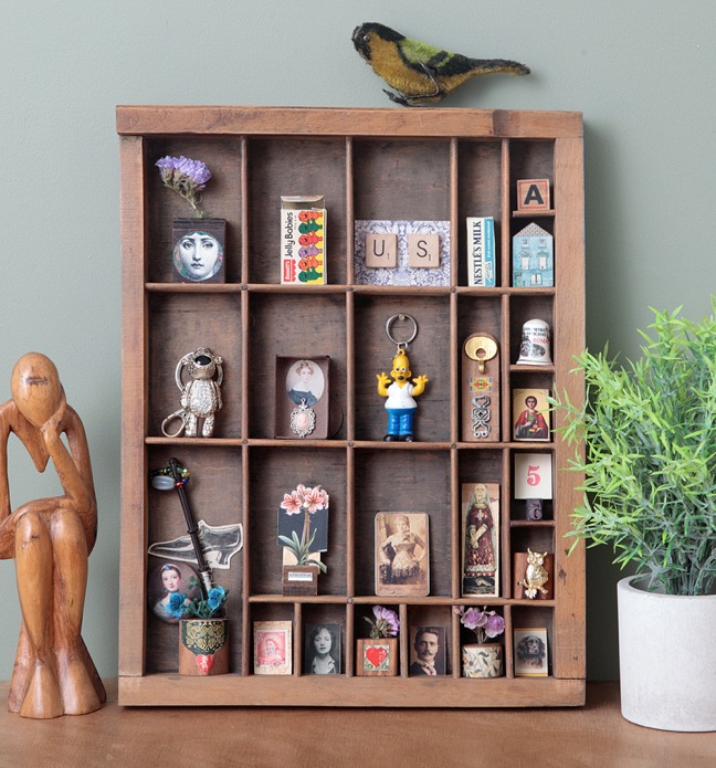 Quirky display of little vintage items in an old printers tray type case drawer