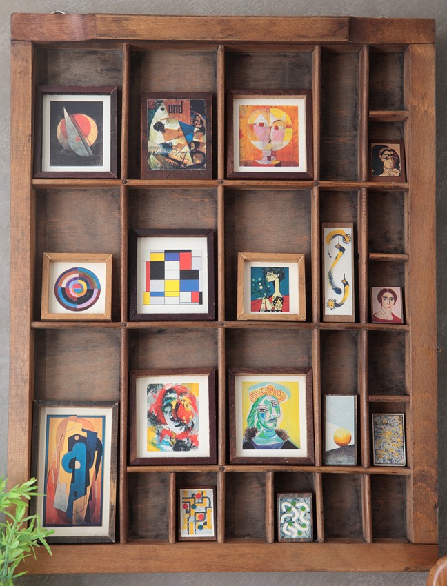 Early 20th Century modernist portrait paintings in Old Type case cabinet