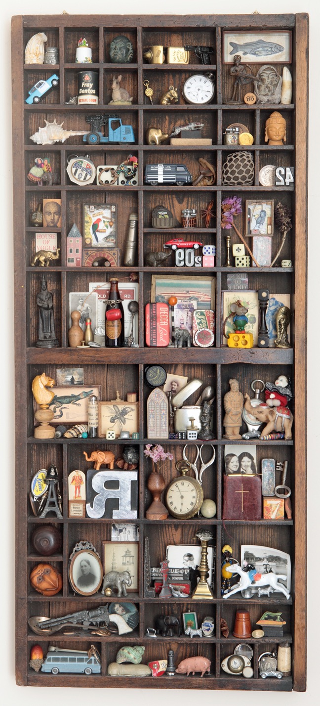 100's of little vintage curios from around the world displayed in an Antique letterpress printers type case